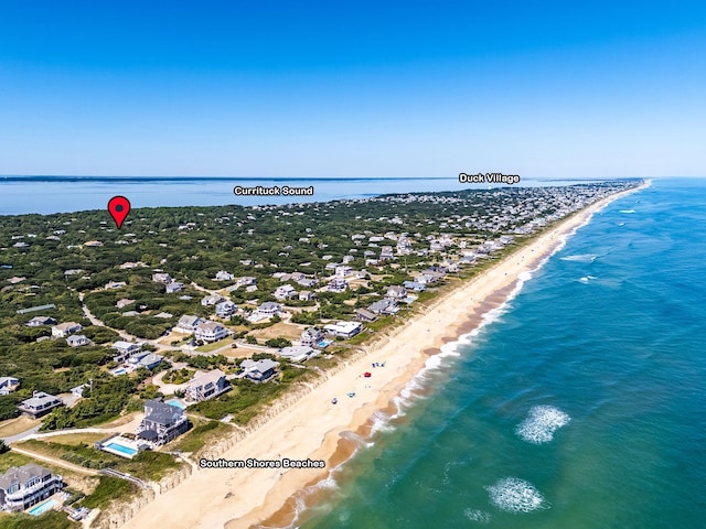 birds eye view of property with a water view, a residential view, and a beach view