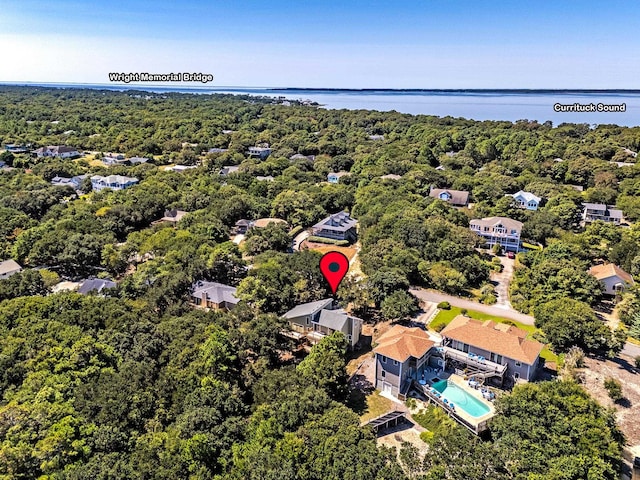 aerial view with a water view and a view of trees