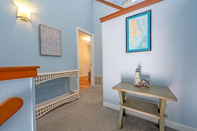 bedroom with carpet floors, visible vents, and baseboards