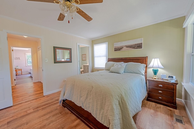 bedroom with light wood-style floors and crown molding