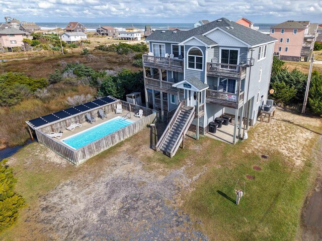 23211 Sea Oats Dr Lot 2, Rodanthe, NC 27968 - back of property featuring a balcony, a shingled roof, and a community pool