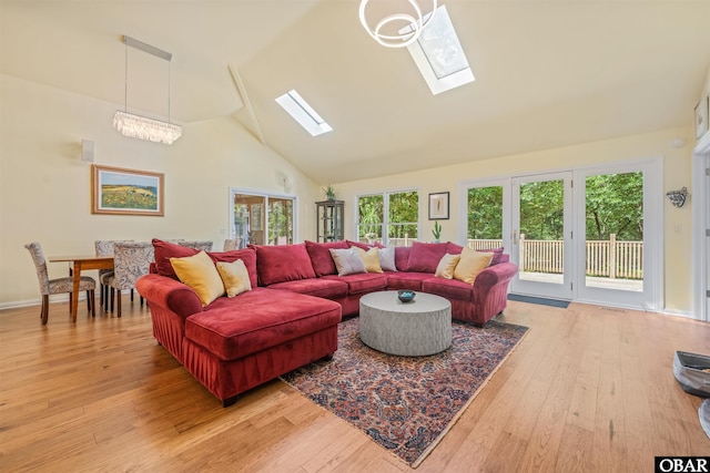 41 Eagles Nest Ln Lot 372, Southern Shores, NC 27949 - living room featuring a skylight, plenty of natural light, light wood-style floors, and high vaulted ceiling