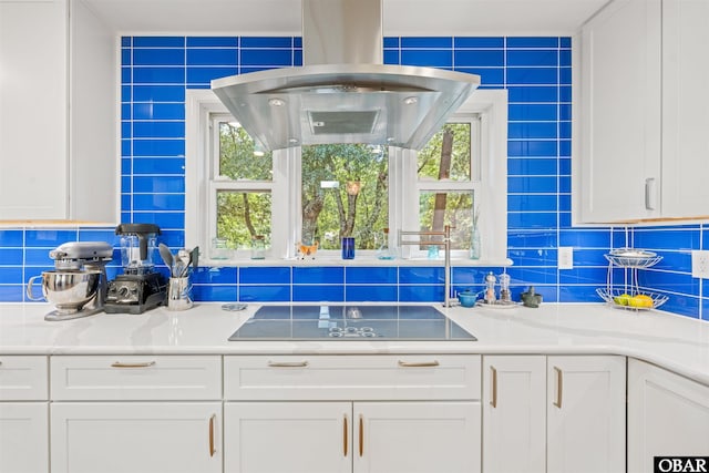 41 Eagles Nest Ln Lot 372, Southern Shores, NC 27949 - kitchen with black electric cooktop, white cabinetry, island range hood, decorative backsplash, and light countertops