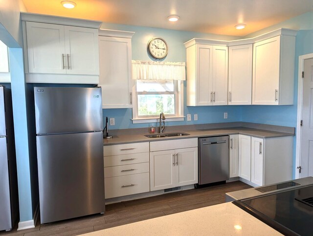 415 British Cemetery Rd Lot # 1 & 2, Ocracoke, NC 27960 - kitchen featuring appliances with stainless steel finishes, a sink, white cabinetry, dark wood-style floors, and light countertops