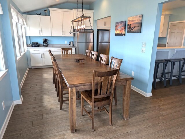 415 British Cemetery Rd Lot # 1 & 2, Ocracoke, NC 27960 - dining room with baseboards, dark wood-style flooring, lofted ceiling, and a chandelier