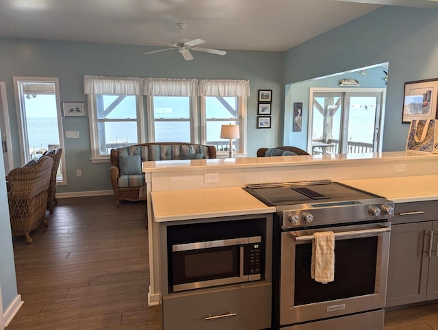 415 British Cemetery Rd Lot # 1 & 2, Ocracoke, NC 27960 - kitchen featuring appliances with stainless steel finishes, light countertops, baseboards, dark wood-style flooring, and ceiling fan