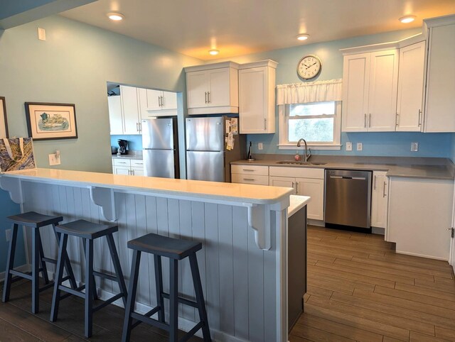 415 British Cemetery Rd Lot # 1 & 2, Ocracoke, NC 27960 - kitchen with appliances with stainless steel finishes, a sink, white cabinetry, dark wood-style flooring, and recessed lighting