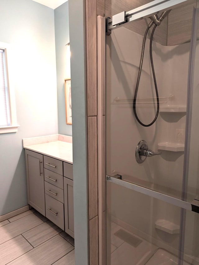 415 British Cemetery Rd Lot # 1 & 2, Ocracoke, NC 27960 - bathroom with a stall shower, vanity, wood finished floors, and baseboards