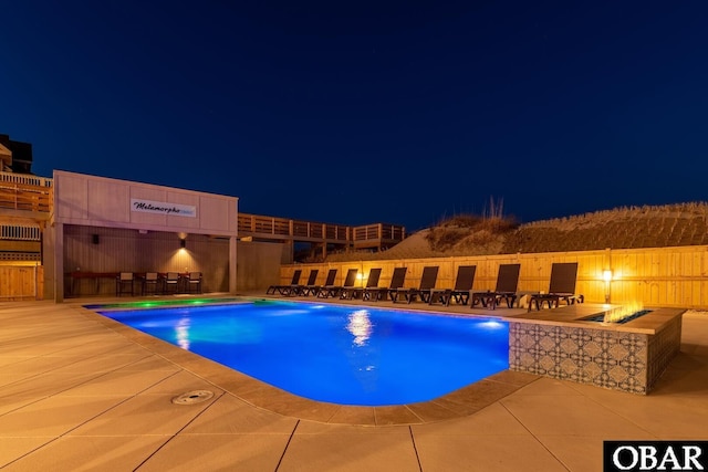 981 Lighthouse Dr Lot 10, Corolla, NC 27927 - pool at twilight featuring a patio and a fire pit