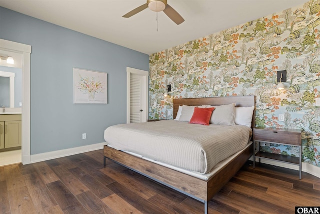 981 Lighthouse Dr Lot 10, Corolla, NC 27927 - bedroom featuring wallpapered walls, wood finished floors, ensuite bath, and an accent wall