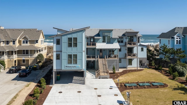 981 Lighthouse Dr Lot 10, Corolla, NC 27927 - view of property featuring a water view, stairs, and concrete driveway