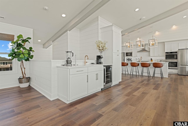 981 Lighthouse Dr Lot 10, Corolla, NC 27927 - indoor wet bar with beverage cooler, refrigerator, dark wood finished floors, built in microwave, and stainless steel double oven