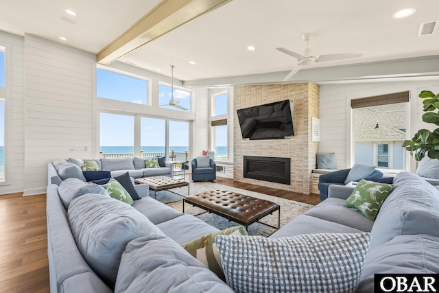 981 Lighthouse Dr Lot 10, Corolla, NC 27927 - living area with ceiling fan, wood finished floors, beam ceiling, a fireplace, and recessed lighting