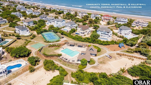 bird's eye view featuring a water view and a beach view