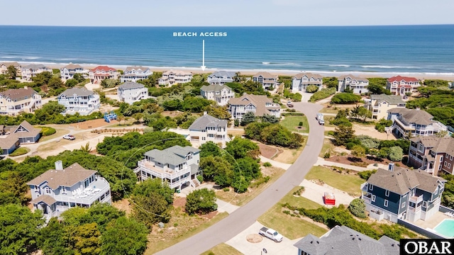drone / aerial view featuring a beach view and a water view