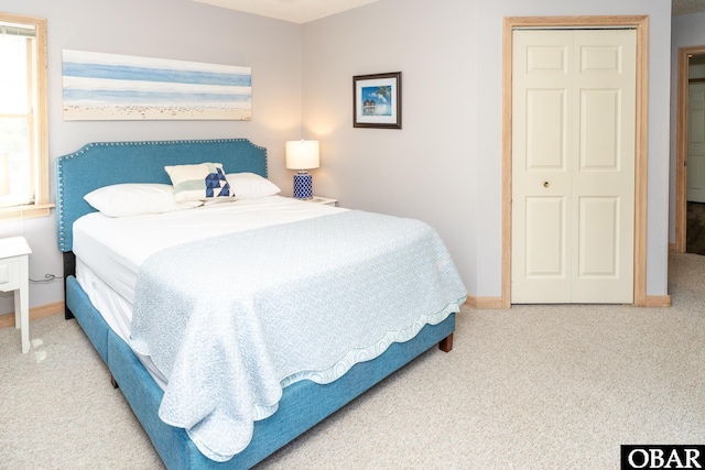 bedroom featuring carpet floors and baseboards