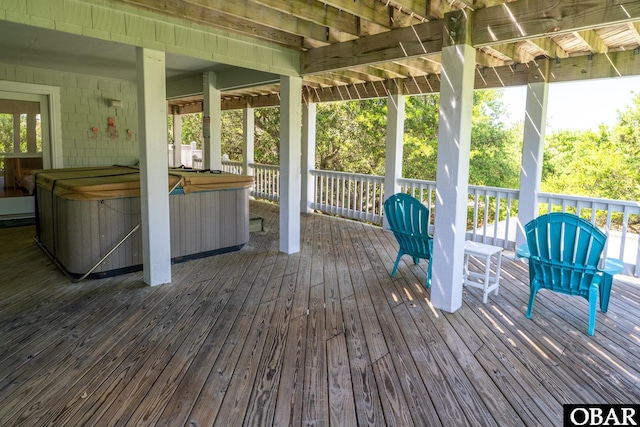 wooden deck featuring a hot tub