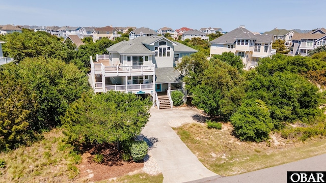 457 N Cove Rd Lot 44, Corolla, NC 27927 - view of front of home with a balcony, a residential view, and stairway