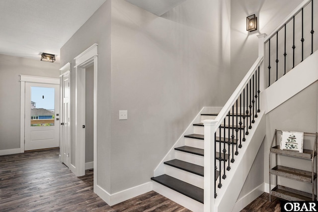 stairway with baseboards and wood finished floors