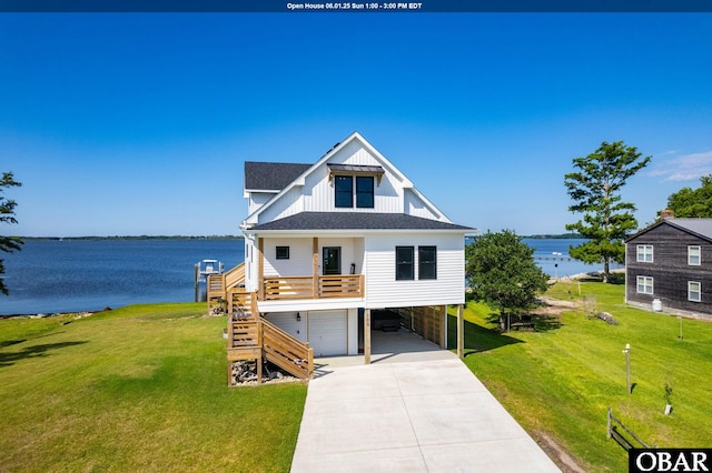 105 Baggy Davis Ln Lot 20B, Currituck, NC 27929 - view of front facade with board and batten siding, stairway, a garage, a water view, and concrete driveway