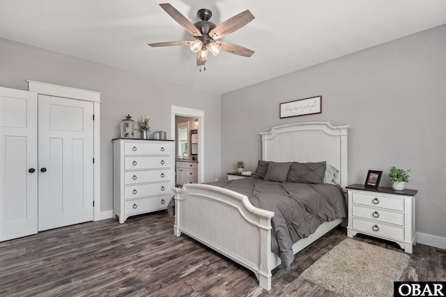 bedroom featuring ensuite bath, baseboards, dark wood finished floors, and a ceiling fan