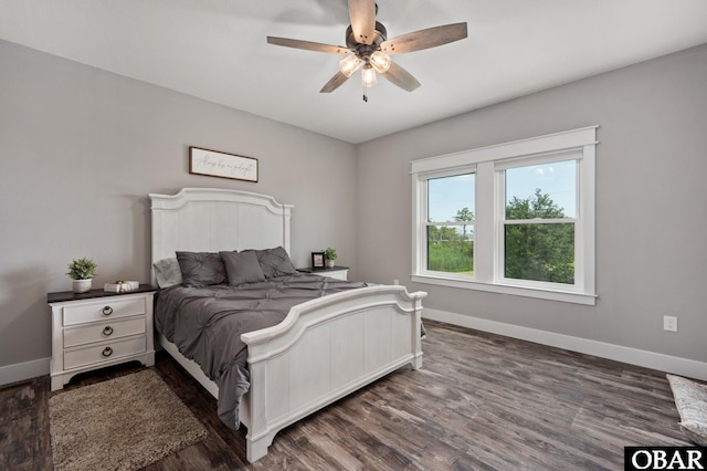 bedroom with dark wood-style floors, baseboards, and a ceiling fan