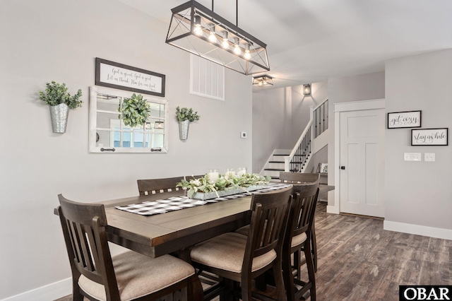 dining area with dark wood-style floors, stairway, and baseboards