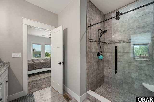 ensuite bathroom with ensuite bathroom, a shower stall, visible vents, and tile patterned floors