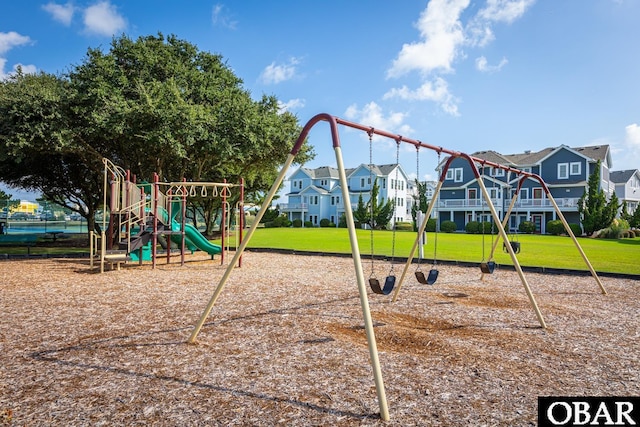 community jungle gym featuring a residential view and a yard