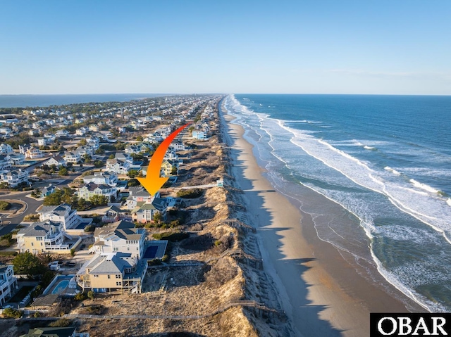 drone / aerial view with a water view, a residential view, and a beach view