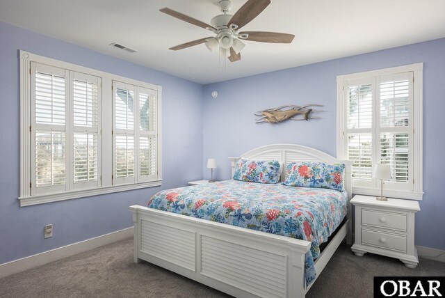 carpeted bedroom featuring baseboards, visible vents, and a ceiling fan