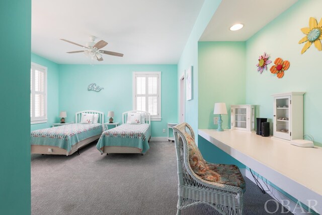 bedroom featuring ceiling fan, dark carpet, and baseboards