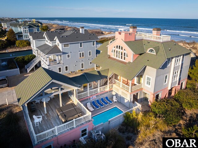 bird's eye view with a residential view, a water view, and a beach view