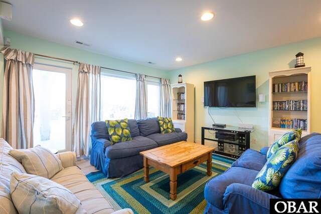 living area with visible vents and recessed lighting