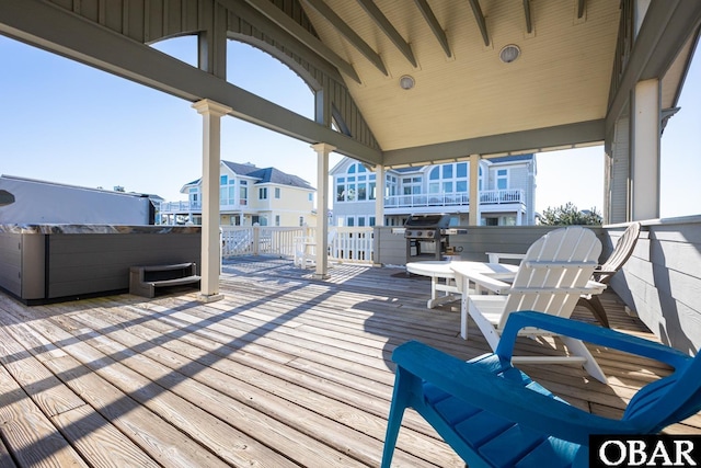 wooden terrace featuring grilling area and an outdoor hot tub