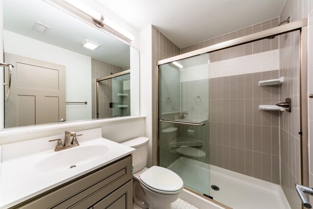 bathroom featuring a stall shower, vanity, and toilet