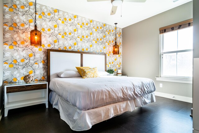 bedroom featuring a ceiling fan and baseboards