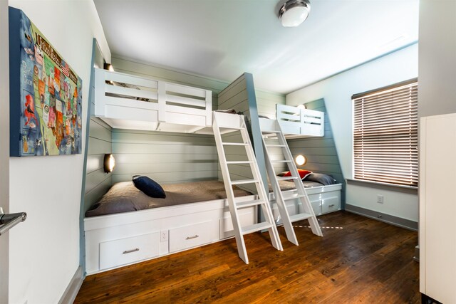 bedroom featuring dark wood finished floors and baseboards