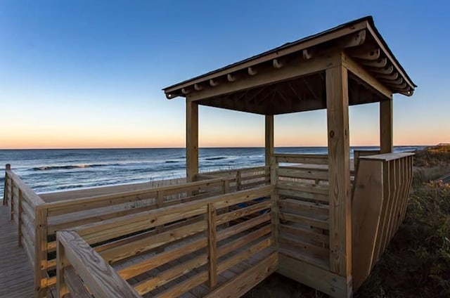 view of community with a view of the beach, a water view, and a gazebo