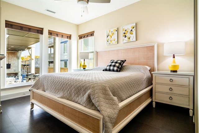 bedroom featuring a ceiling fan, visible vents, and baseboards