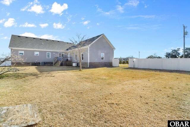 view of yard featuring fence and stairway