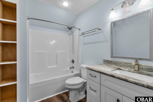 full bathroom featuring toilet, wood finished floors, vaulted ceiling, vanity, and shower / bathing tub combination