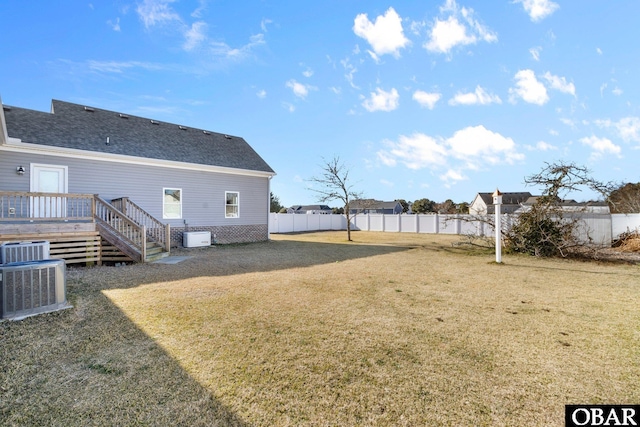 view of yard featuring stairway, fence, central AC, and a wooden deck