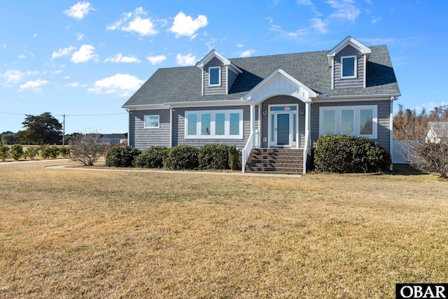 cape cod house with roof with shingles and a front yard