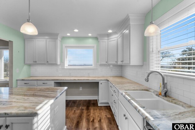 kitchen with white cabinetry and pendant lighting