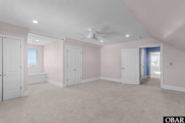 additional living space featuring lofted ceiling, recessed lighting, baseboards, and light colored carpet