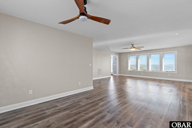 unfurnished living room featuring baseboards, visible vents, ceiling fan, and dark wood-type flooring