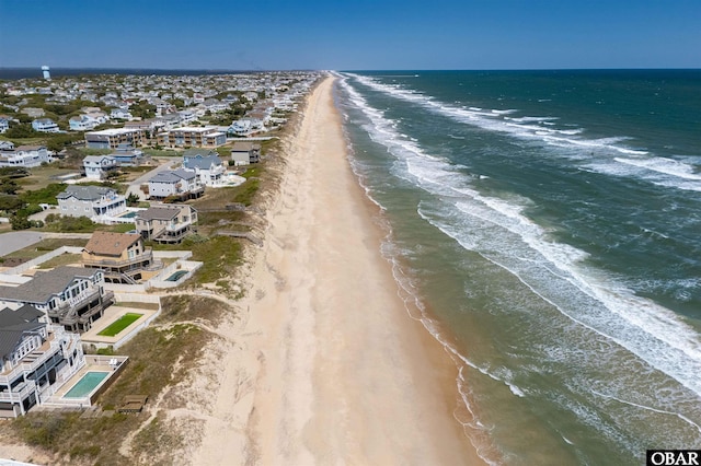 birds eye view of property with a water view and a view of the beach