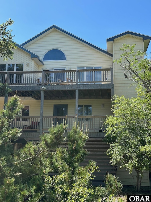 rear view of property featuring a balcony