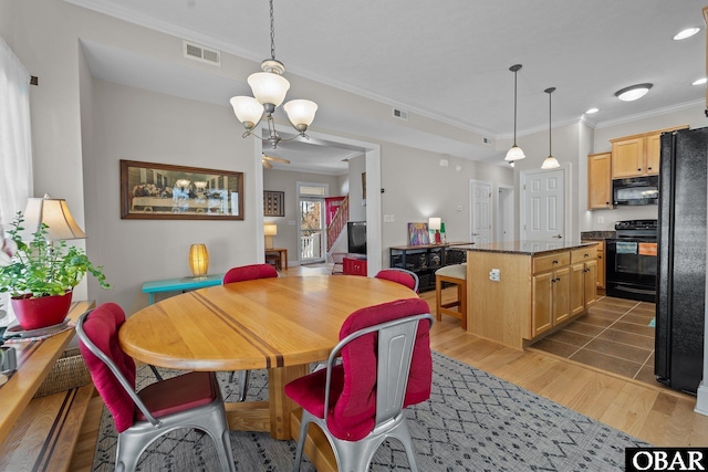 dining area with an inviting chandelier, crown molding, visible vents, recessed lighting, and light wood-type flooring